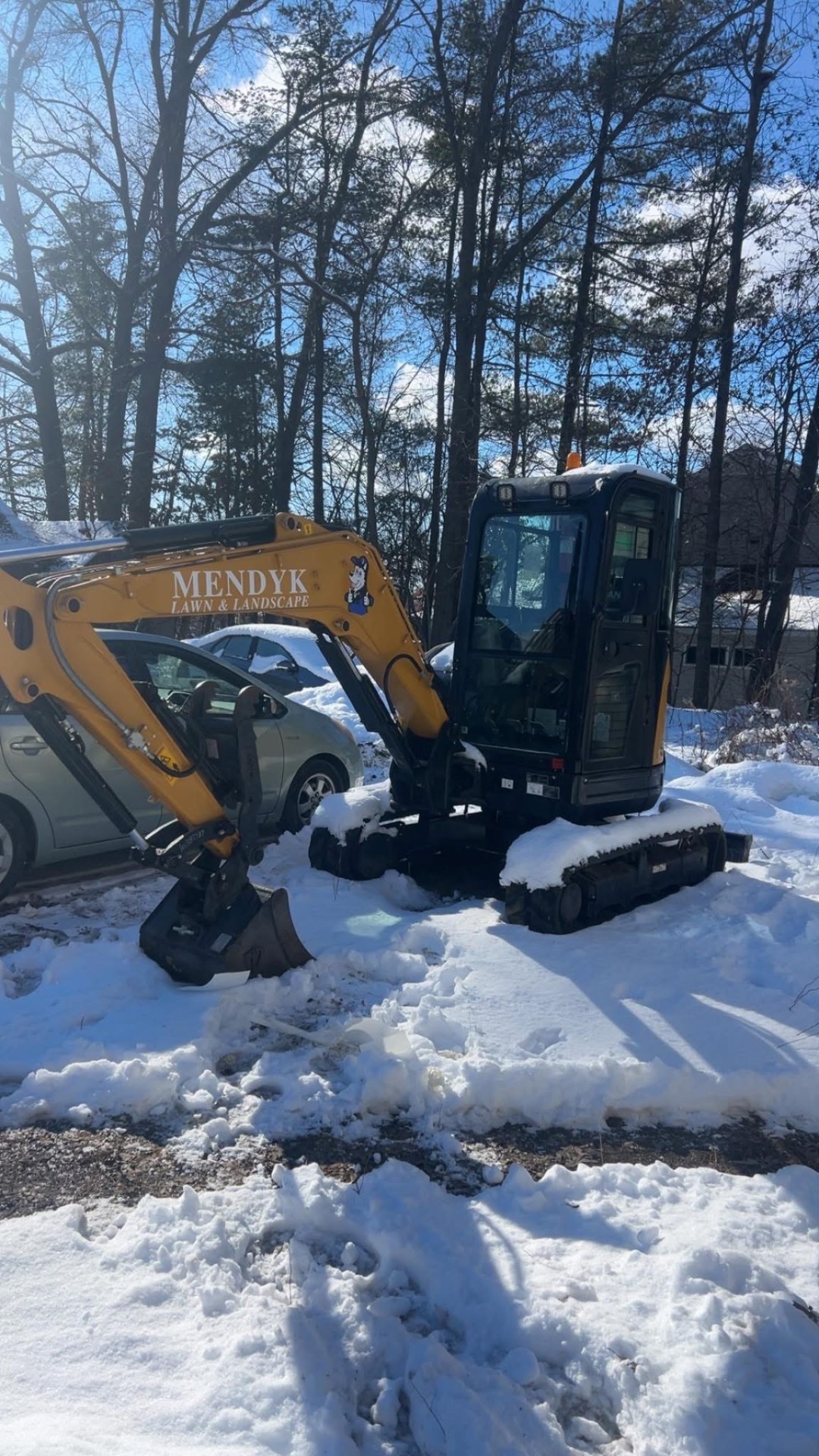 Mendyk excavator on a snow covered work site